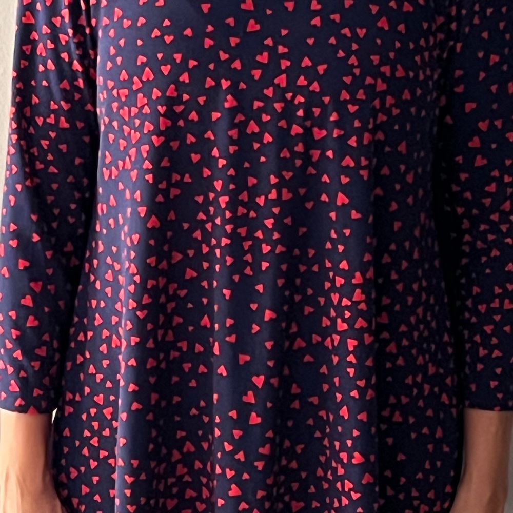 Blue pullover with red heart print.